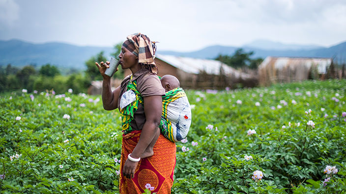 Woman carrying baby on her back in Tanzania